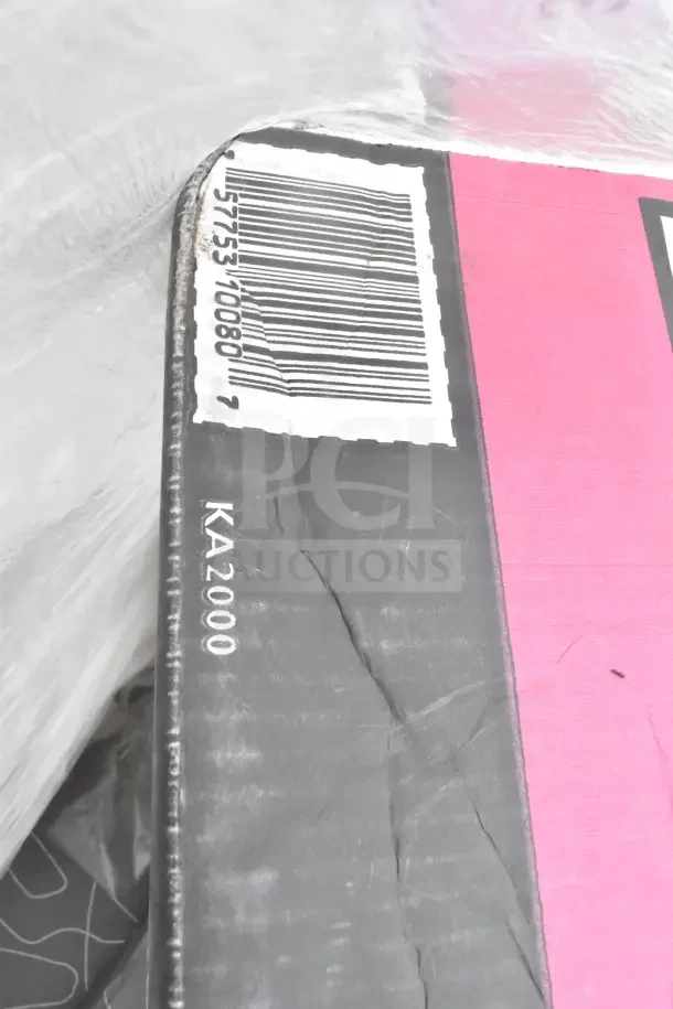 Close-up of a scratched box corner showing a barcode and "KA2000" label, part of a kitchen set auction lot.