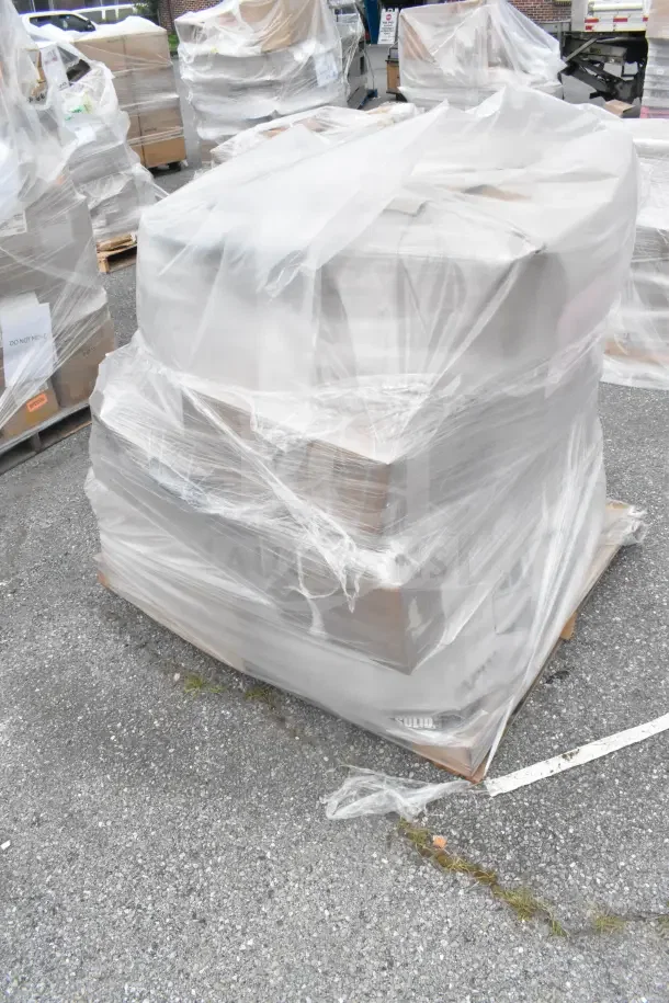 Shrink-wrapped pallet with seven brand new scratch and dent items including a stock pot, labeled "Do Not Move."