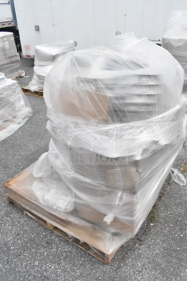 7 new scratch and dent items wrapped on a pallet, featuring a stock pot, covered in plastic for protection.