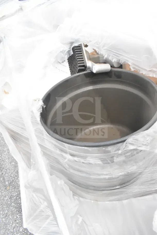 7 brand new scratch and dent items, wrapped; includes stock pot in partial view, showing light surface imperfections.