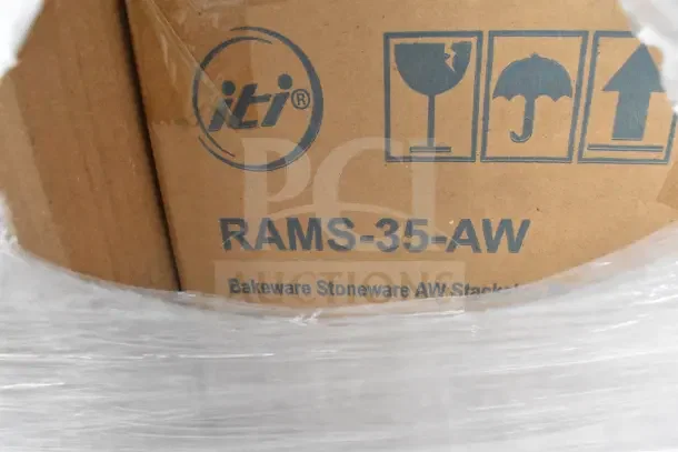 Cardboard box labeled "RAMS-35-AW," containing ITI stoneware bakeware. Markings indicate fragile contents.