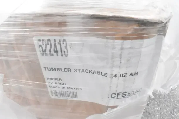 Plastic-wrapped box labeled "Tumbler Stackable 24 oz AM, Made in Mexico, CFS Brands," showing item details for auction.