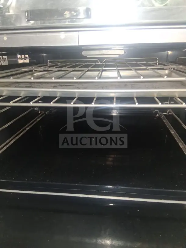 Southbend P32D 32" 4 Burner Gas Range with Standard Oven interior, clean condition, adjustable racks visible.