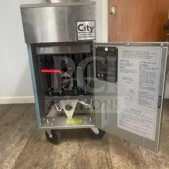Brand new City Cooking 4 tube deep fryer, model CCF4-NG, 120000 BTU. Stainless steel, on wheels, with open instruction panel.