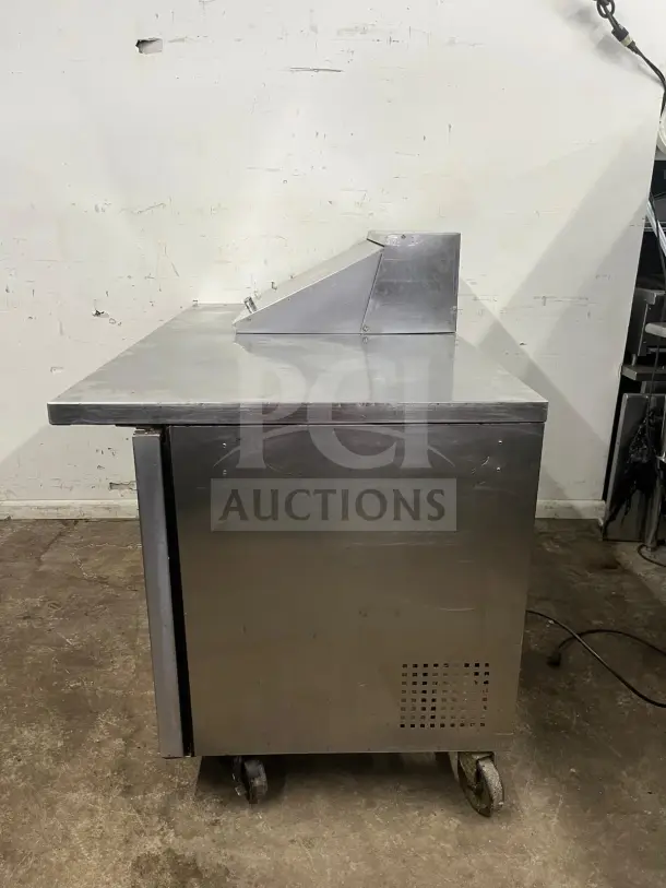 TRUE TSSU-60-12M refrigerated prep table, two doors, stainless steel, includes 12 pans, on casters, used condition.