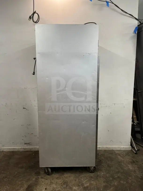 Traulsen G10010 30" G Series solid door reach-in refrigerator, right hinged, silver, visible wear, on casters.