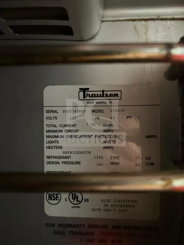 Traulsen G10010 refrigerator label showing serial number, model, electrical specifications, and compliance certifications.