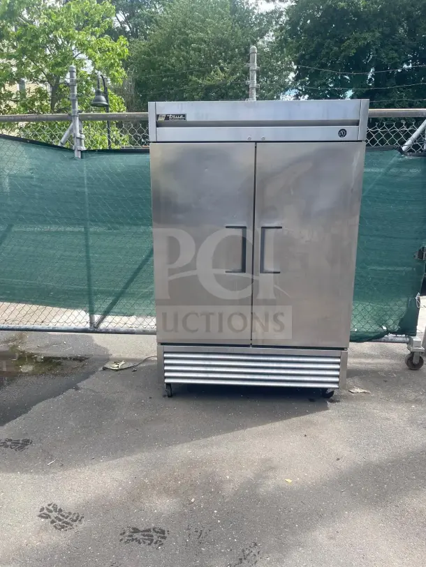 TRUE T-49 54" stainless steel reach-in refrigerator with two solid doors on casters, exterior in used condition.