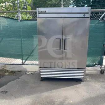 TRUE T-49 54" stainless steel reach-in refrigerator with two solid doors on casters, exterior in used condition.