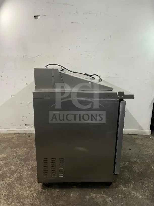 Kelvinator KCHMT48 48" prep table with refrigerated base, stainless steel, side view, power cord visible, good condition.