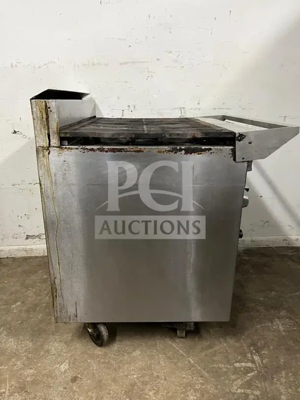 JADE Bistro Series 6-burner charbroiler with oven. Commercial grade, stainless steel, used condition, caster wheels.