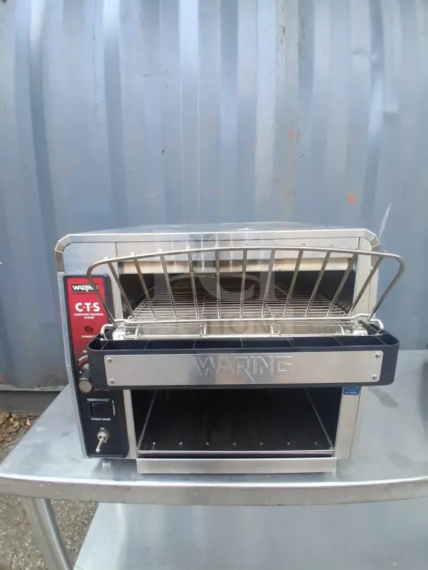 Waring CTS1000 commercial conveyor toaster, stainless steel, NSF certified, 450 slices/hour, visible brand label, used condition.