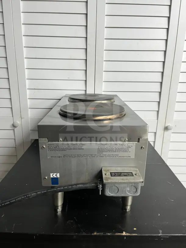 Star-Max 602HF 12" electric hot plate with dual burners, stainless steel finish, and visible safety labels indicating installation warnings.