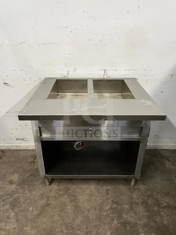 24" stainless steel electric steam table with dual compartments, visible under-shelf, and temperature control; used condition.