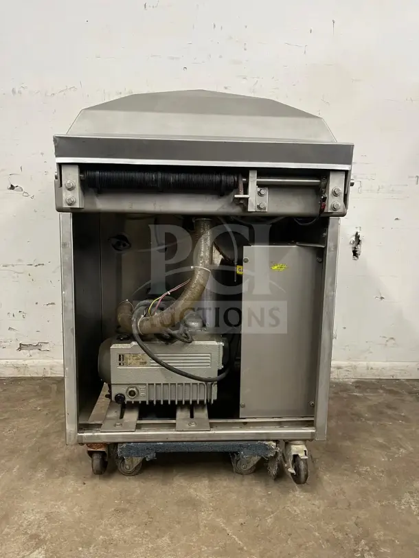 Berkel steel vacuum packaging machine, very good condition, internal components visible, mounted on wheels.