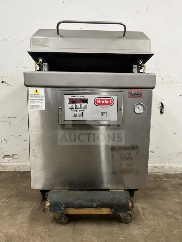 Very good condition Berkel vacuum packaging machine, stainless steel, model labeled "vacuum machine," control panel and gauge visible.