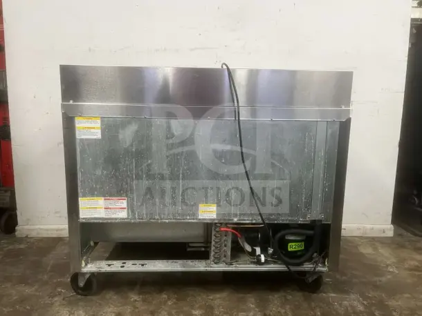 Beverage-Air 48" 2 Door Sandwich Prep Table, model PREP TABLE, stainless steel, caster wheels, minor surface wear. Tags show caution details.