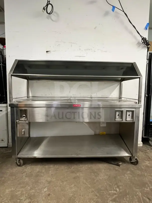 Gaylord stainless steel hot food steam buffet table, model BUFFET TABLE, features durable construction, wheels, and caution hot label.