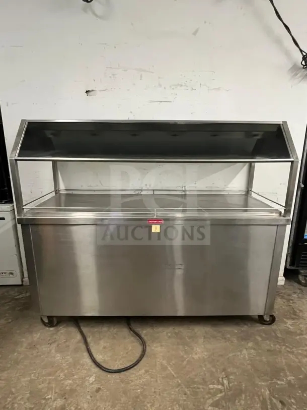 Stainless steel Gaylord hot food steam buffet table in used condition, model BUFFET TABLE, with a glass canopy and caster wheels.