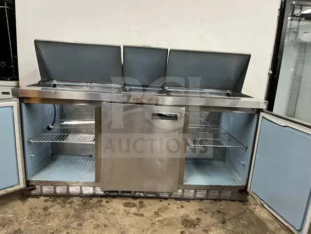 72" stainless steel sandwich/salad prep table with refrigerated base, model preptable. Features mega top lids, shelves, signs of wear.