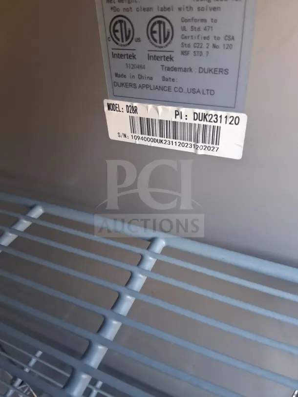 Dukers D28R Reach-In Refrigerator, model label and interior shelving, excellent condition, right hinge solid door.