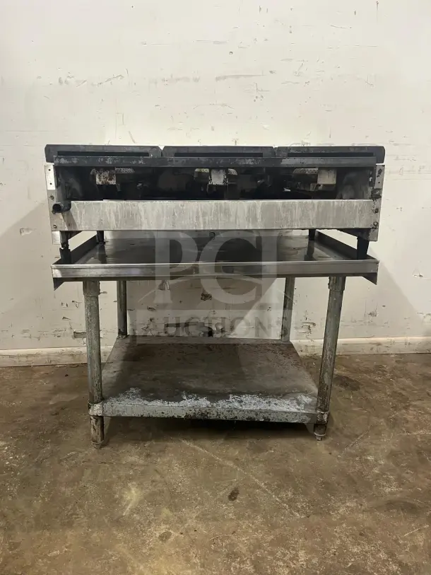 AMERICAN RANGE ARHP-36-6 griddle with 3/4" thick hot plate, 36" wide, 6 burners. Heavy duty, visible wear, on metal stand.