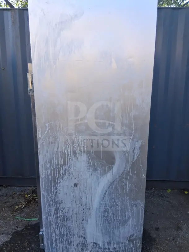 Traulsen G20010 52" G Series solid door refrigerator with visible wear and stains. Left/right hinged doors, outdoor setting.