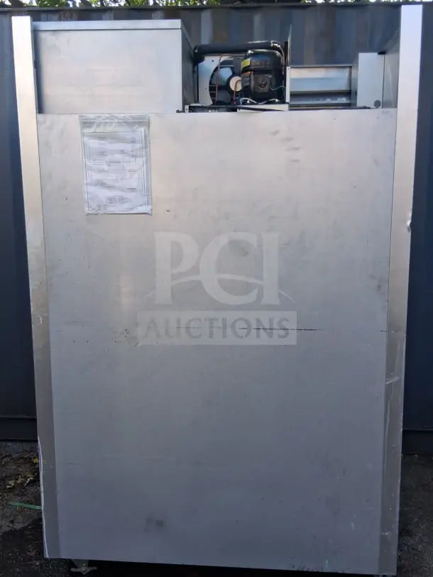 Traulsen G20010 52" G Series reach-in refrigerator, solid doors, visible compressor, and attached service documentation.