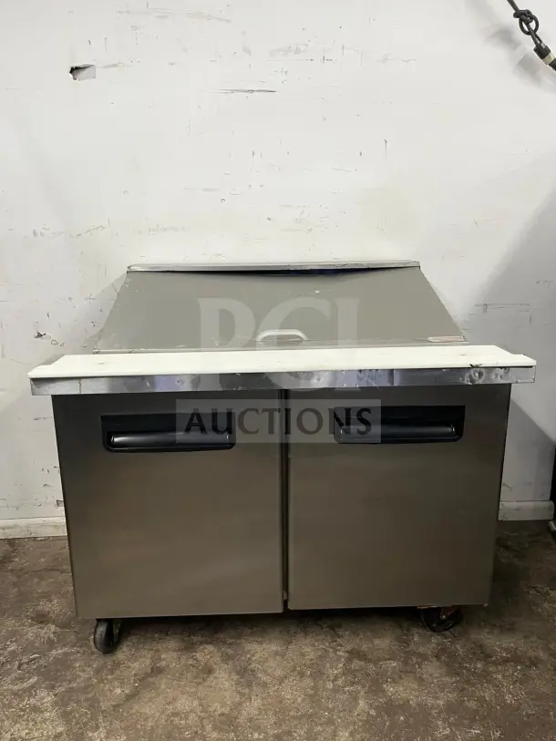 Blue Air BLMT48-HC 48" refrigerated prep table with two swing doors, used condition, stainless steel, 13.1 cu. ft. capacity.