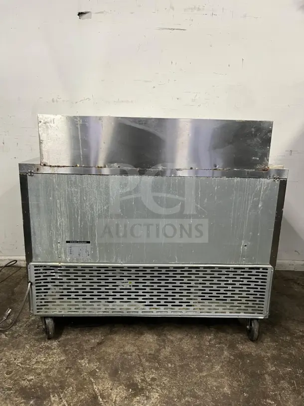 Blue Air BLMT48-HC 48" refrigerated prep table, swing doors, 13.1 cu. ft., visible wear, mounted on wheels, back view.