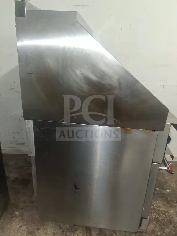 Vulcan 36C-6BN Endurance natural gas range, stainless steel, side view, showing signs of wear.