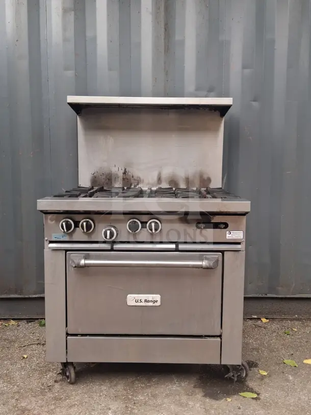 U.S. Range 36" natural gas 6-burner range with standard oven, used condition, visible wear on surface, model label intact.