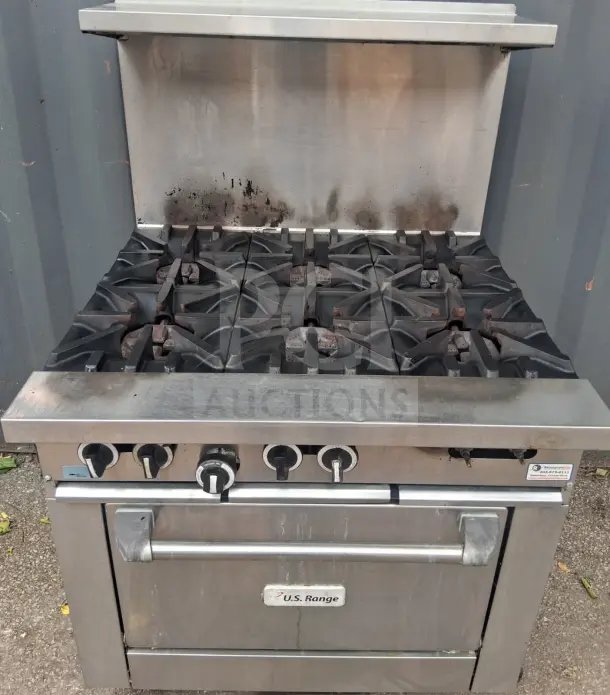 U.S. Range natural gas 6-burner, 36" range with standard oven. Used condition, visible grime on burners, U.S. Range label.