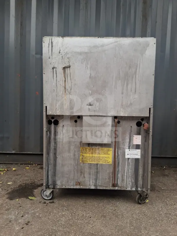 U.S. Range natural gas 6 burner with 36" oven, worn condition, visible warning and instruction labels.