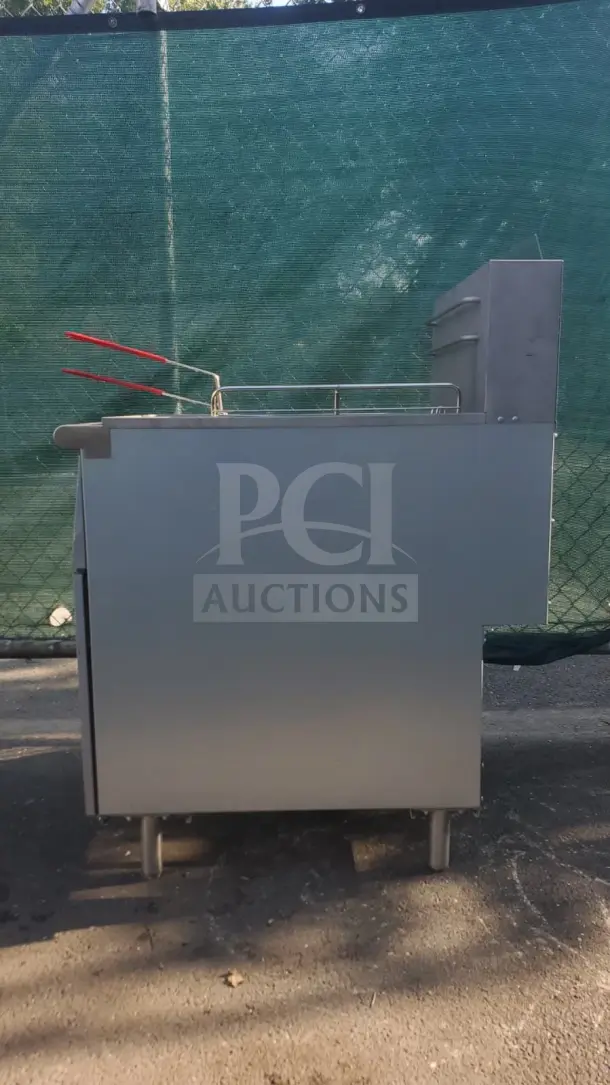 Rocket Cooking 40 lb Capacity Commercial Gas Floor Fryer, silver finish, side view with red-handled baskets, in excellent condition.