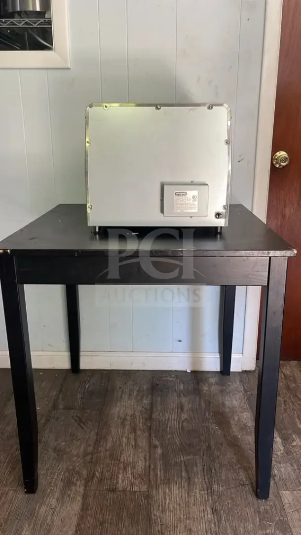 Waring CTS1000 Commercial Conveyor Toaster on table, unlit, rear view showing model label, 120V, gently used condition.