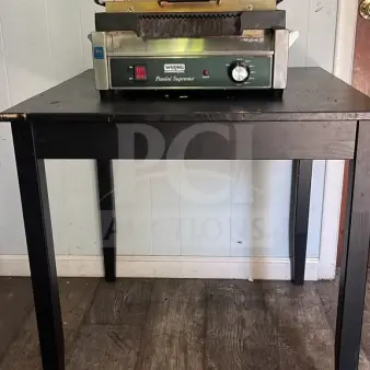 Waring WPG250TB Panini Supremo grill, grooved plates, timer, 14 1/2" x 11" surface, 208V, 2808W, on a table, used condition.