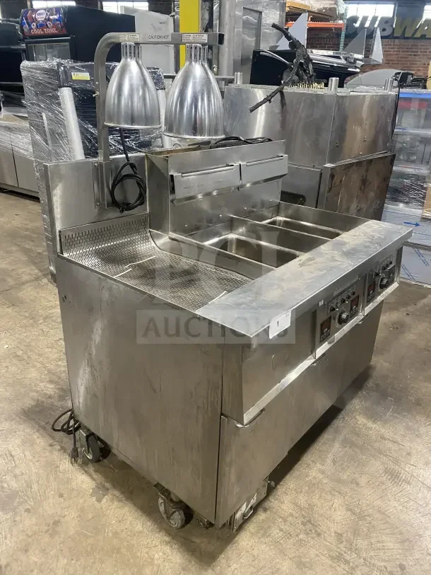 Keating 14TSSI Dual Fryer, stainless steel, natural gas, with backsplash, heating element, and casters, model: 14TSSI, SN: FE46064.