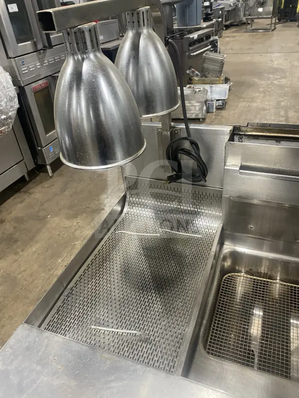 Keating 14TSSI stainless steel natural gas fryer with heating element and backsplash, 120V 1-phase, on casters, SN: FE46064.