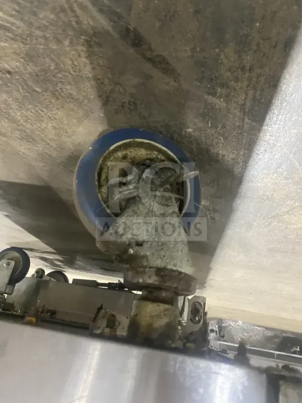 Keating Model 14TSSI dual fryer caster wheel, showing wear and dirt, part of a stainless steel gas fryer unit.