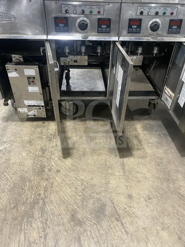 Keating 14TSSI stainless steel dual fryer, natural gas, with heating element, backsplash, and casters, Model: 14TSSI.