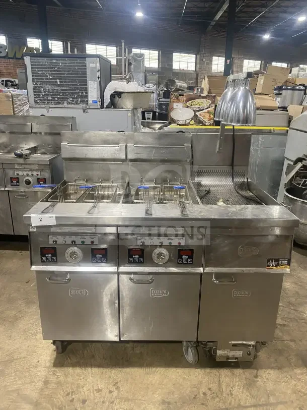 Keating stainless steel dual instant recovery fryer, model 14TSSI, natural gas, with heating element, backsplash, on casters.