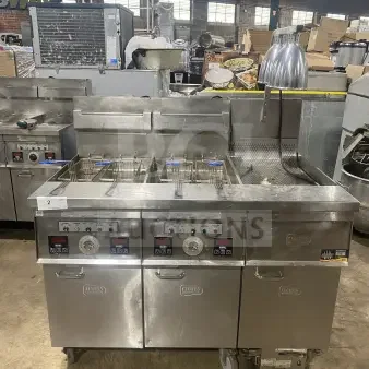 Keating stainless steel dual instant recovery fryer, model 14TSSI, natural gas, with heating element, backsplash, on casters.