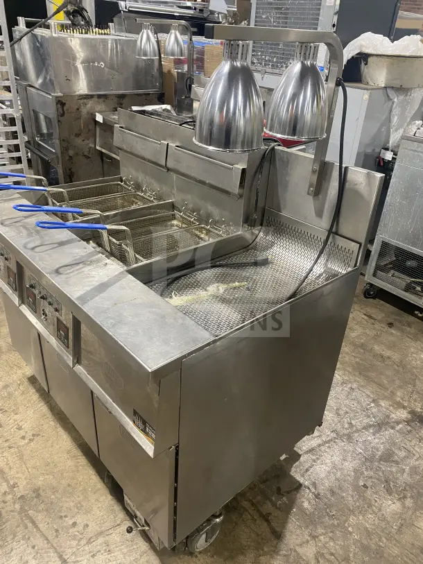 Keating 14TSSI stainless steel natural gas fryer, dual instant recovery with heating element, backsplash, on casters.