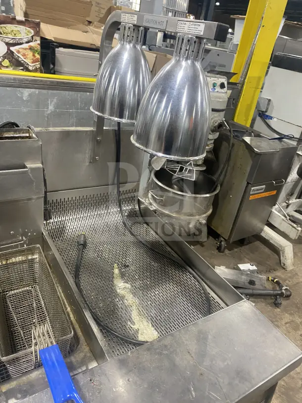 Keating stainless steel dual fryer, model 14TSSI, natural gas, with heating element, back splash, on casters, 120V 4 phase.