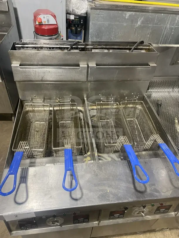 Keating 14TSSI stainless steel dual fryer, natural gas powered, with heating element, backsplash, on casters. Model FG45764.