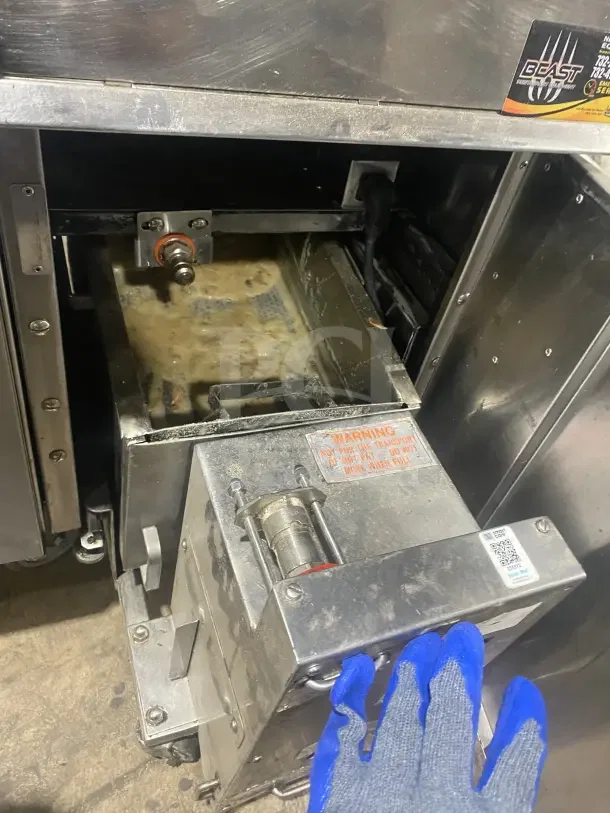 Keating 14TSSI stainless steel gas fryer with heating element, backsplash, on casters. Model 14TSSI, SN: FG45764, 120V 4 Phase.