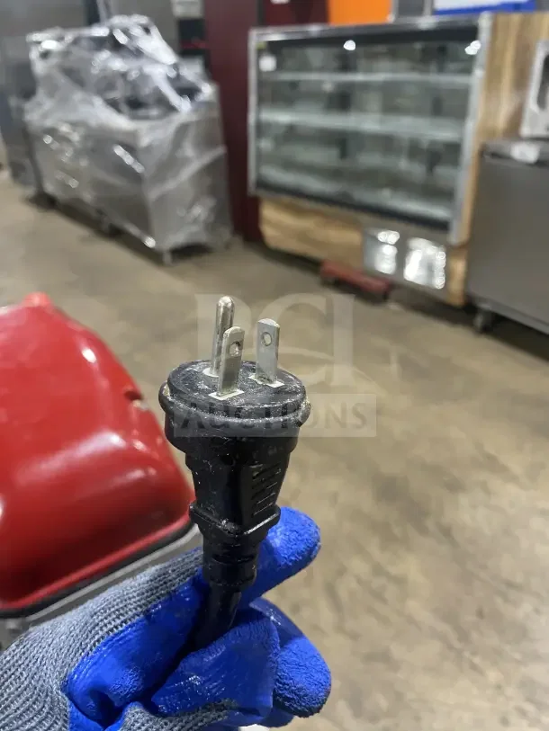 Axis AX-M30 commercial mixer cord in gloved hand. 110V 1 Phase plug. Multi-use, heavy-duty, electric-powered appliance.
