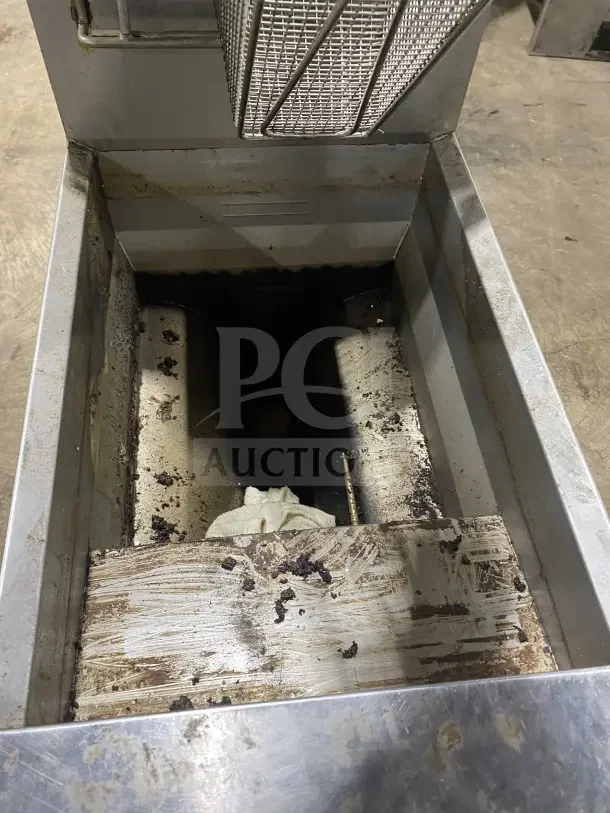 Frymaster commercial stainless steel gas deep fryer with backsplash, basket hanger, and fry basket. On casters, used condition.