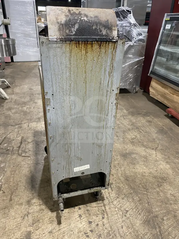 Frymaster commercial stainless steel gas fryer, with back splash and basket hanger. Includes fry basket, mounted on casters. Signs of wear.